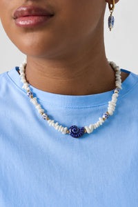 Necklace with stone beads, white beads with blue flowers and statement shell