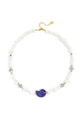 Necklace with stone beads, white beads with blue flowers and statement shell