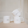 Set van 3 witte mokken met de teksten "ik hou van ons", "je t'aime" en "c'est la vie"