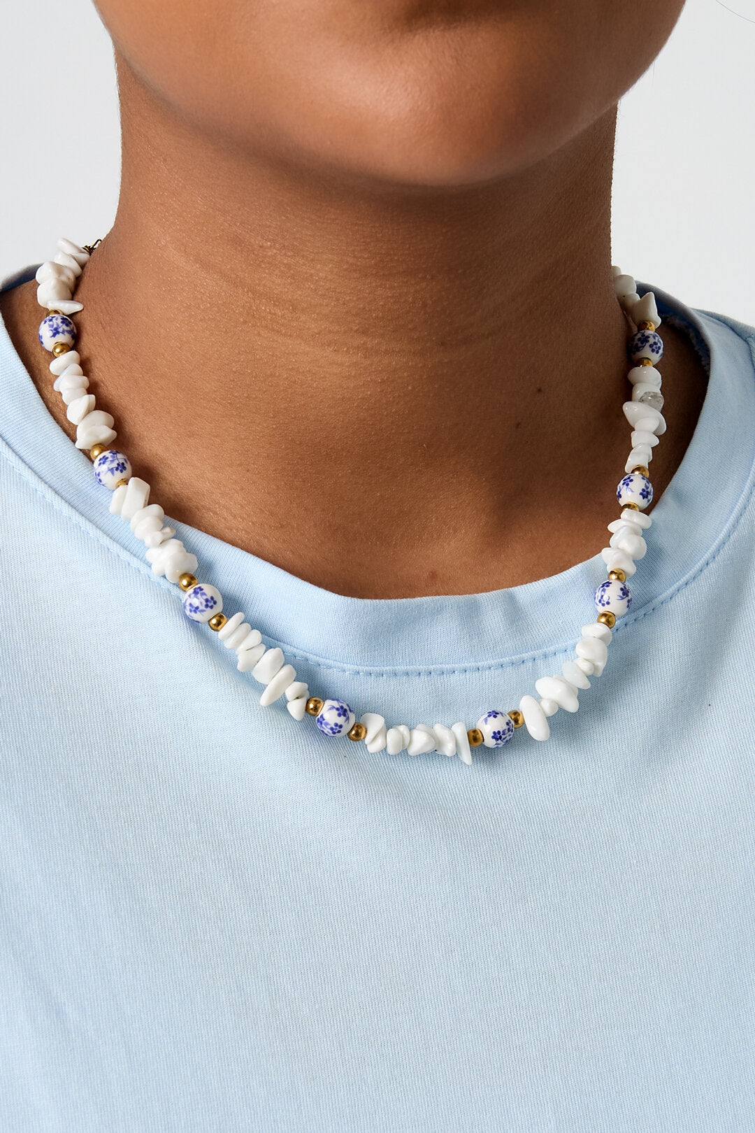 Necklaces with stone beads and white beads with blue flowers