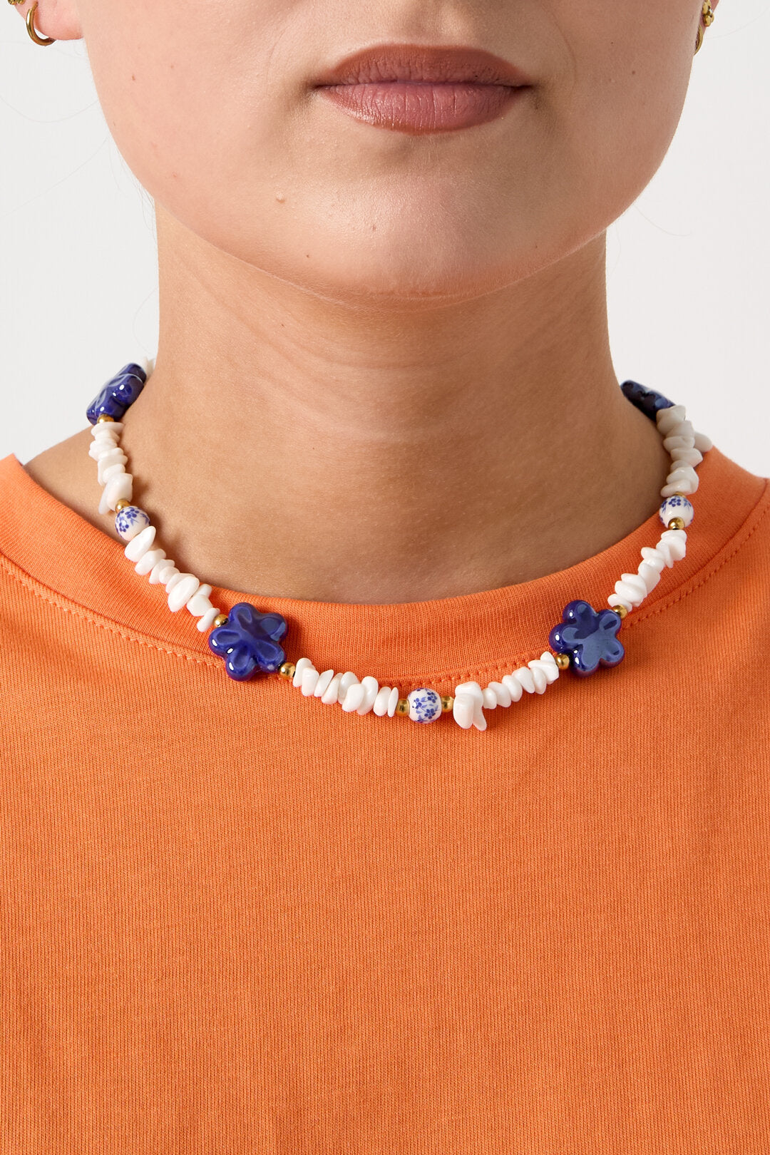 Necklace with stone beads, white beads with blue flowers and statement flowers